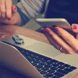 closeup of person holding phone and credit card